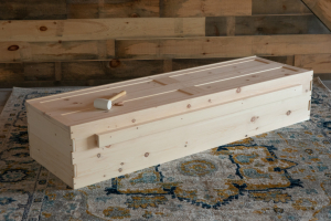 Simple pine casket with mallet for assembly